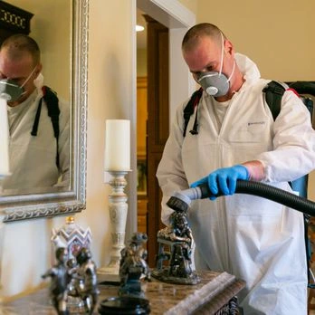 Technician performing HEPA-filtered cleaning as part of a preventive mold visit
